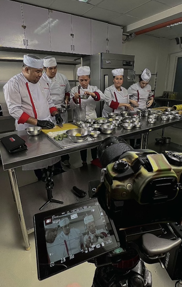 Chef Abby and the kitchen team at the prep line during a filmed session